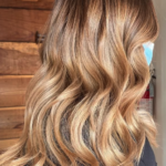 Person with wavy, caramel-blonde hair.